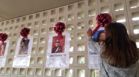 A student at Wellington High School hangs a photo of shooting victim Carmen Schentrup.