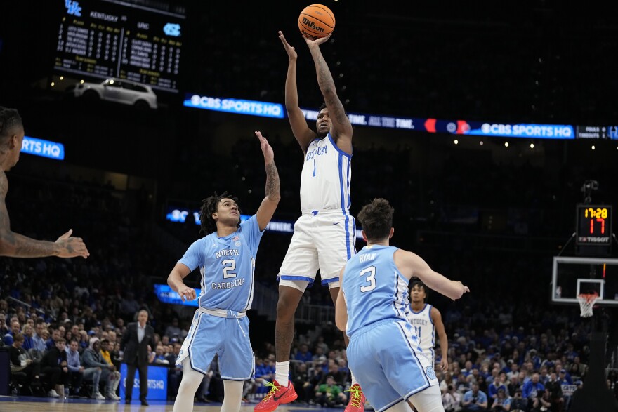 Kentucky guard Justin Edwards (1) shoots against North Carolina guard Elliot Cadeau (2) during the first half of an NCAA college basketball game in the CBS Sports Classic, Saturday, Dec. 16, 2023, in Atlanta, Ga. (AP Photo/Brynn Anderson)