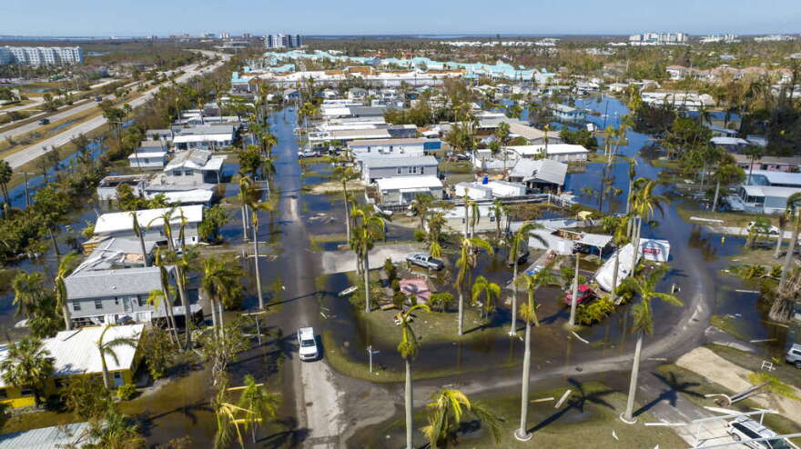 Water floods a damaged trailer park in Fort Myers on Saturday, after Hurricane Ian passed by the area. AP Photo: Steve Helber