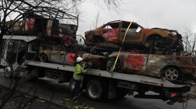 A worker secures burned-out cars onto a truck in the Coffey Park neighborhood on Nov. 13, 2017 in Santa Rosa, Calif. (Justin Sullivan/Getty Images)