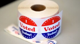 A spool of stickers rests on a table at a polling station during Massachusetts state primary voting, Sept. 3, 2024, at the Newton Free Library, in Newton, Mass.