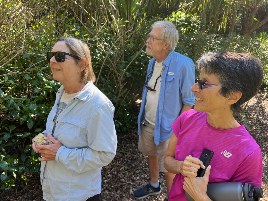 Gill and Hank Murrey and Ellen Hales (at right) delight in the Pelican Cove community's butterfly garden