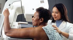A patient gets a breast cancer screening.
