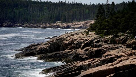 Visitors explore the rocky coast of Acadia National Park, Saturday, June 11, 2022, near Bar Harbor, Maine. The park recorded more than 4 million visitors in 2021. (Robert F. Bukaty/AP)