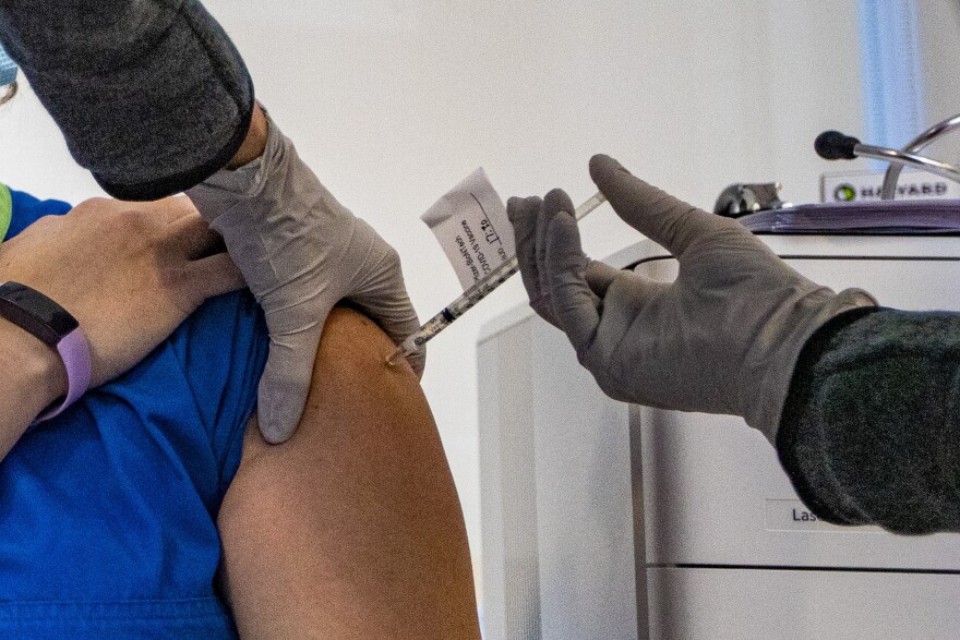 Pfizer's COVID-19 vaccination is administered to a Tufts Medical Center employee on Dec. 15. (Jesse Costa/WBUR)