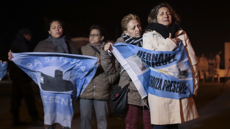 Relatives of crew members on board the ARA San Juan submarine wait outside the navy base in Mar del Plata. Argentina's navy announced early Saturday the missing submarine has been located in a deep ravine in the Atlantic Ocean.