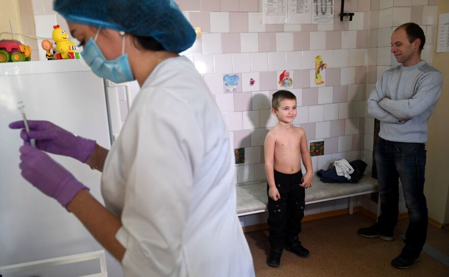 A nurse prepares a syringe for a measles vaccination at a pediatric clinic in Kiev, Ukraine. The country had 72,408 measles cases in the year from March 2018 to February 2019 — the highest number for any country during that period.