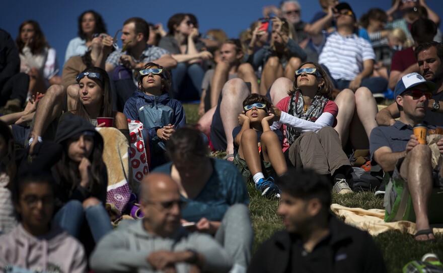 A crowd of people gathered at Gas Works Park on Monday, August 21, 2017, to watch the solar eclipse in Seattle. KUOW Photo/Megan Farmer