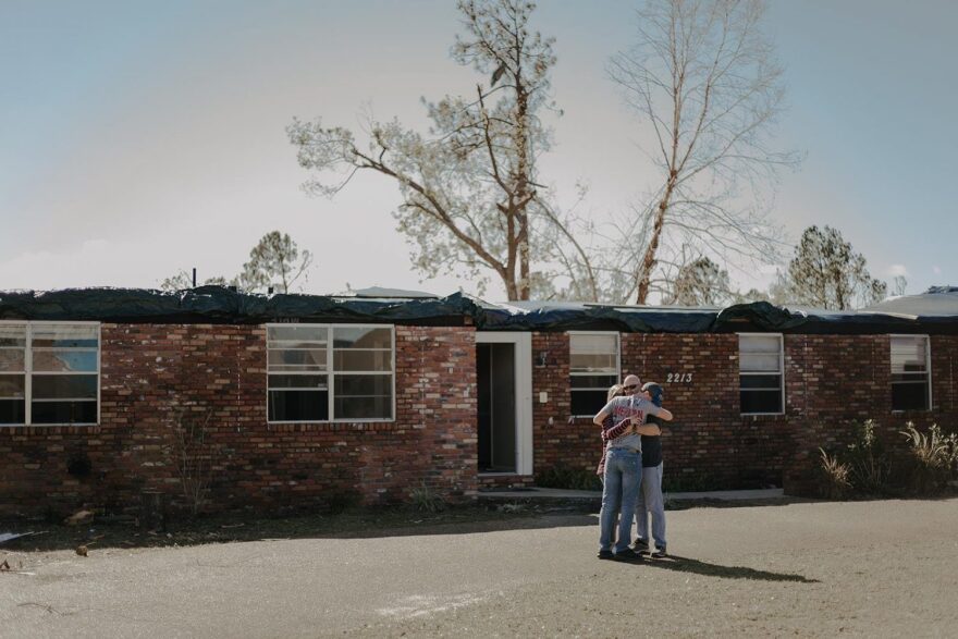 Another Panhandle family huddles outside their damaged home. They were forced to buy a camper to live in temporarily after their roof caved in during the storm. (Photo courtesy of Cierra Camper)