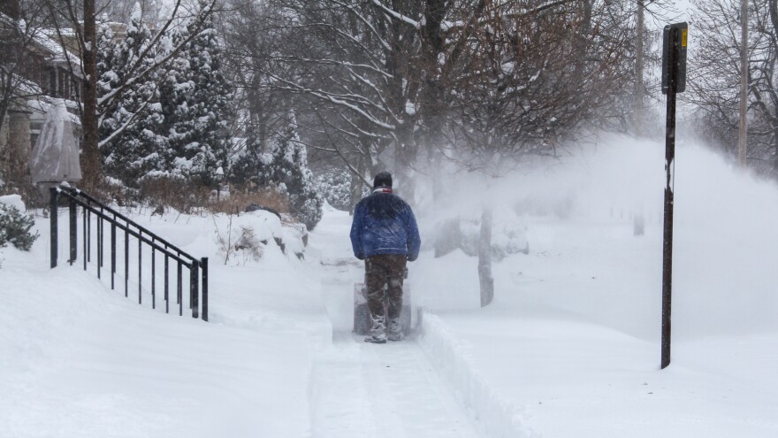 A man uses a snowblower to clear a sidewalk near Franklin Park in Columbus on Sunday afternoon, Jan. 25, 2026.