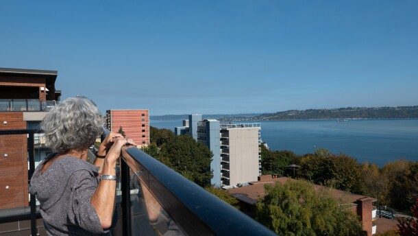 Miriam Barnett looks out at Commencement Bay from the roof of the YWCA of Pierce County's Dorothy Height Apartments.