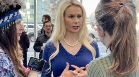 Kelly Tshibaka speaks to a reporter after a candidate forum in 2022. (Liz Ruskin/Alaska Public Media)