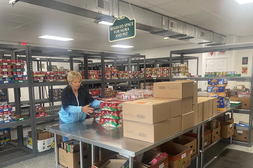 Nora Lane, a longtime volunteer at the Gateway Food Pantry in Arnold, Missouri, sorts through a recent grocery delivery.