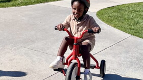 Preschoolers at Spokane's Logan/Lidgerwood Head Start Center ride tricycles during a recess break.