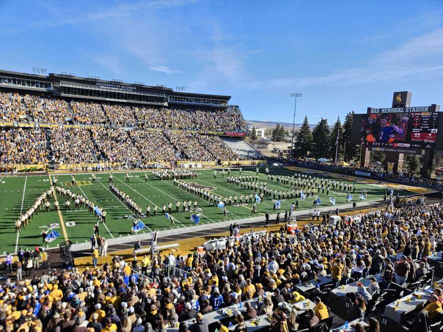 Members of the Western Thunder Marching Band spell out Josh Allen's last name in front of packed stands.