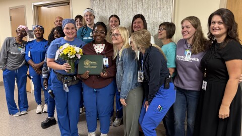 Shana Bennefield, center, holds her DAISY award with her nursing colleagues at Essentia Health in Fargo.