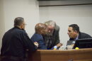 A huddle between North Port Police Department Chef Todd Garrison, City Manager Jerome Fletcher, Mayor Pete Emrich, and City Attorney Michael Fuino during a raucous meeting on data centers.
