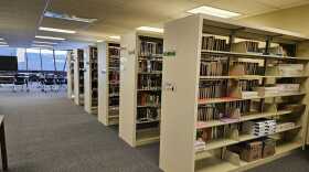 A school library with half empty shelves.