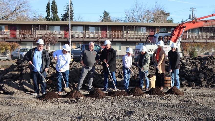Representatives from companies and government entities involved in building Whiteaker Commons take part in a December 1, 2025 ceremonial groundbreaking.