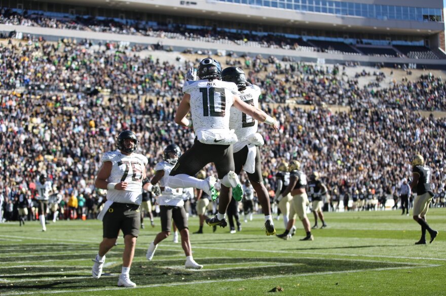 Bo Nix (10) and Bucky Irving (8) celebrate an Oregon touchdown on Sat., Nov. 6, in Boulder, CO.