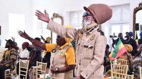 Pictured: Members of the Rastafarian community participate in prayer during a commemoration ceremony at Government House on St. Croix.