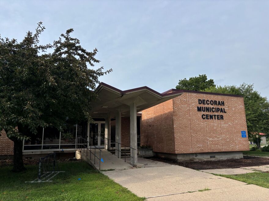 A brown brick municipal building in Decorah, Iowa on a warm evening. 