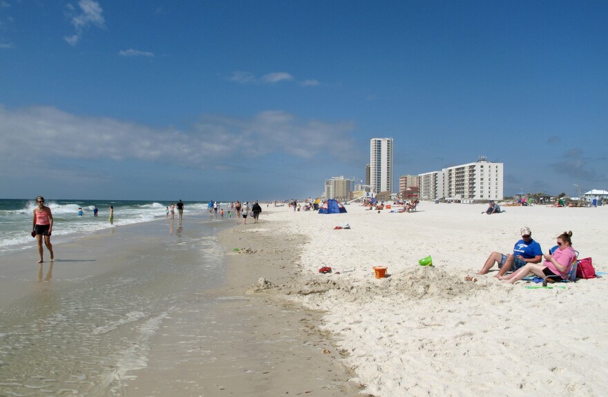 Tourists flock to the beach in Gulf Shores, Ala.