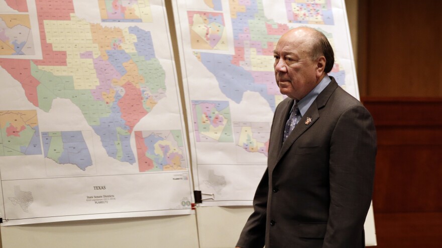 State Sen. Juan "Chuy" Hinojosa looks at redistricting maps on display in the Texas Senate in 2013 in Austin, Texas. On Monday, the Supreme Court overruled a decision that several of the state's districts had been drawn to minimize minorities' voting power.