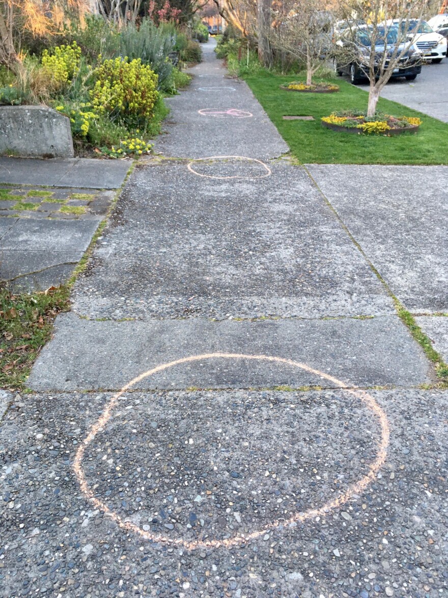 Chalk circles placed ten feet apart denote the extra-safe distance encouraged between dancers at this event.