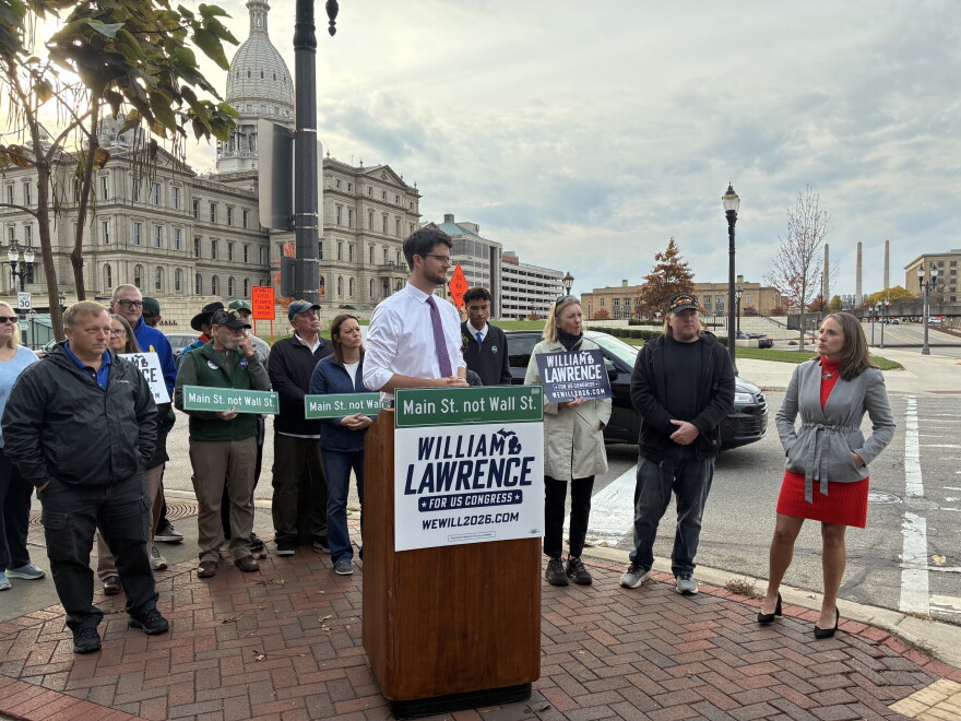 Will Lawrence with supporters and the state Capitol behind him.