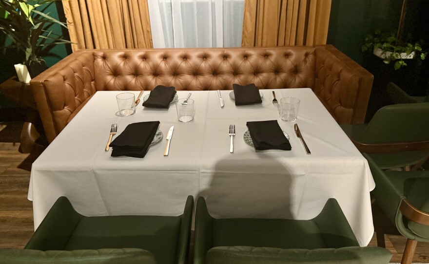 The walls upstairs at Off The Clock, from the stairs to the entrance, are sprawled with work by the restaurant’s resident artist, Haiti-born Rousell Dad.