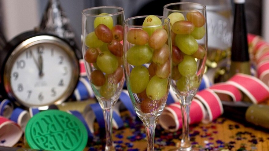 Champagne flutes filled with grapes.