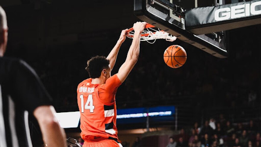 Jesse Edwards `(Orange) catching a lob and throwing it down. These were two of Edwards' 27 points.