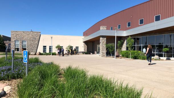 People walk around outside the Cornerstone Church in Ames.