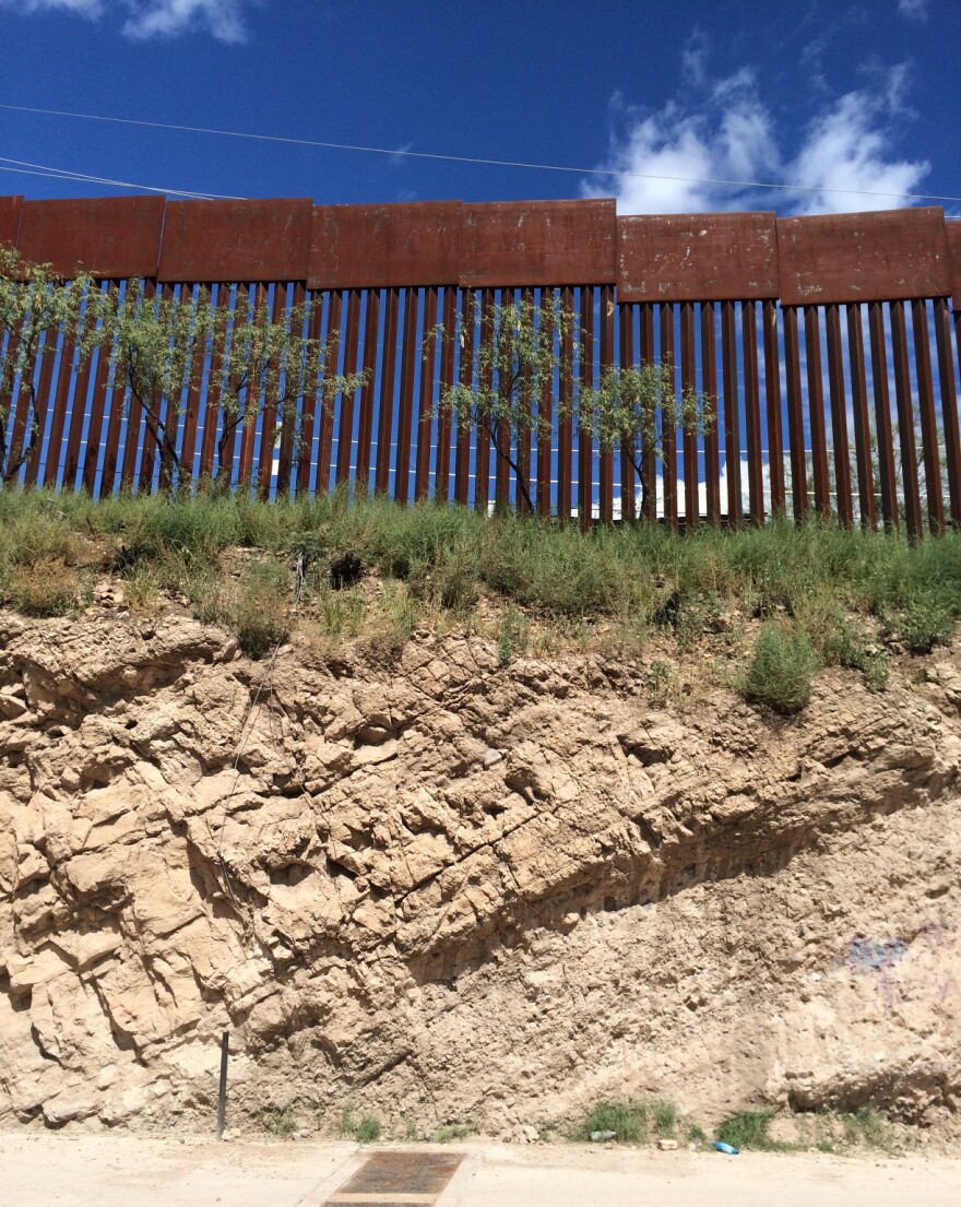 The fence between Nogales, Mexico, and Nogales, Ariz., sits atop a steep embankment. It's 20 to 25 feet high, with 3.5-inch gaps between the bars.