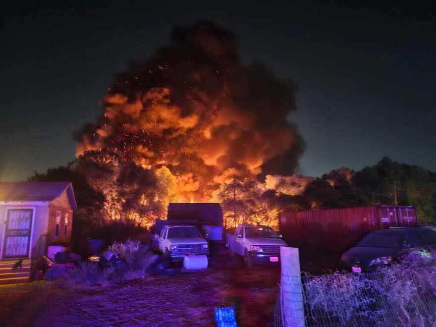 A large grass fire burns 10 acres in the small, unincorporated town of Sand Branch, which doesn't have running water.