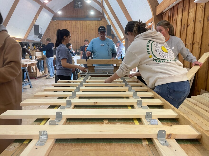 volunteers placing down wood planks