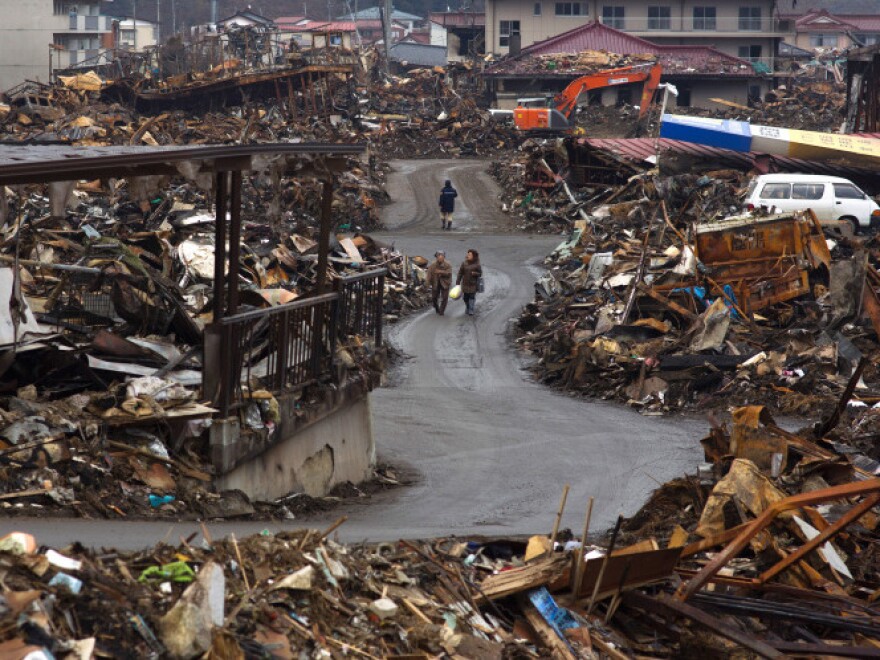 Local residents walk among debris in Kesennuma, Japan, on March 31, just weeks after the quake and tsunami.