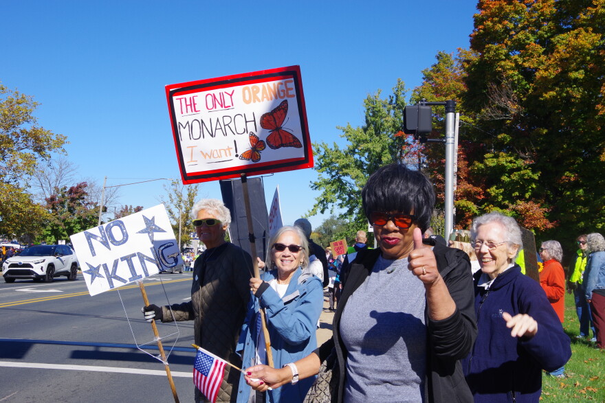 Several woman hold signs on Drake Road.