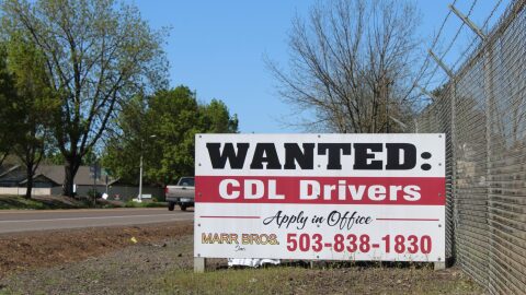 A recruitment sign for commercial truck drivers sits along Oregon Route 99 in Monmouth.