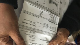 Margaret Lewis examines her latest utility bill from DTE Energy.
