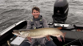Bemidji State University graduate student Baylor Short shows a muskie caught on Leech Lake.