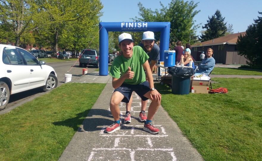 Brandon Johnson and Graham Robinson (behind) share a victory shot after crossing their hopscotch finish line.