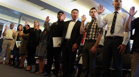 New American citizens take the oath at Seattle City Hall on Flag Day on Sunday.