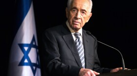 President Shimon Peres addresses members of the Foreign Press Association during a visit to the southern Israeli town of Sderot in July 2014, following Palestinian rocket attacks on the city.