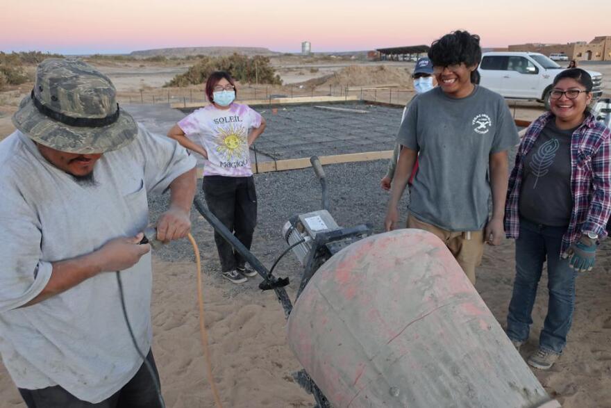 Francisco Mata, left, Kira Nevayaktewa, Quintin Nahsonhoya and Felicia Mata help lay a concrete foundation for a skate ramp on Nov. 6, 2021, in the Village of Tewa on the Hopi reservation in northeastern Arizona. A handful of Hopi youth, including Nevayaktewa and Nahsonhoya, worked together to create the skate spot that opened this spring.