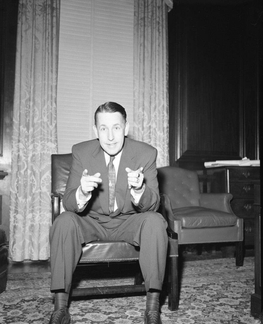 Red Kerce Collection, Governor Charley Johns in a black and white photo, seated in a chair and gesturing with his hands