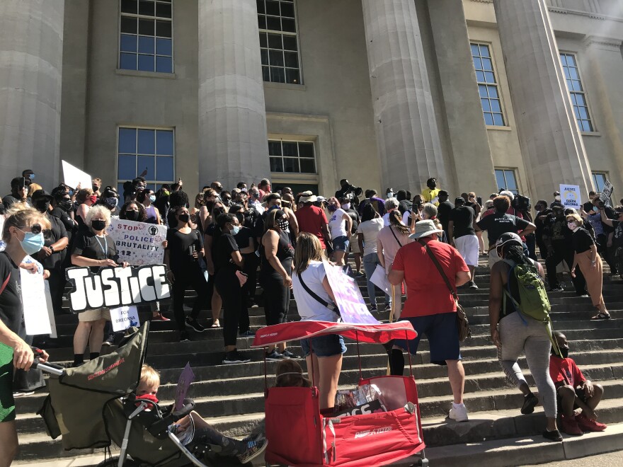 Protesters outside Metro Hall on Monday.