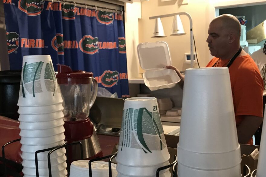 Michael Fiorillo, owner of the Grand Cafe in Gainesville, and his selection of foam to-go boxes and cups, which are not recyclable. (Joshua Baker/WUFT News)