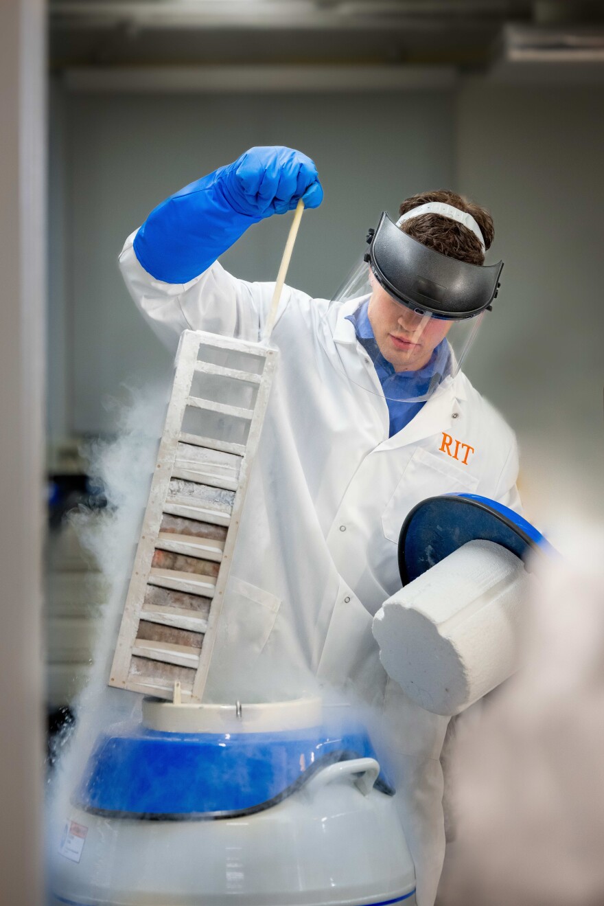 Lute Douglas, a doctoral student in the Rochester Institute of Technology's College of Engineering, pulls a rack out of a biomedical liquid nitrogen tank on Feb. 27, 2026, in RIT's new NanoBio lab at Kate Gleason Hall.
